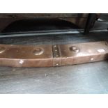 A late 19th century copper fire curb of boss and bow design