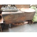 An early 19th century oak dining table on square tapered gate legs