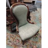 A Victorian walnut and mahogany spoon back chair having later green moquette upholstery on knurl