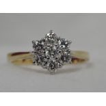 A lady's dress ring having a diamond daisy cluster, total approx 0.4ct in a claw set basket mount on