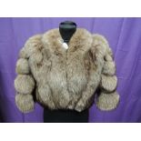 A lady's brown fur and suede evening shoulder jacket having edge to edge fastening