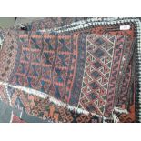 Two early 20th century rugs of Turkman design having russet ground