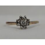 A lady's dress ring having a diamond cluster, total approx 0.35ct in a stepped claw mount to knife