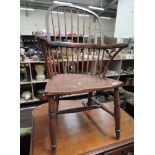 A 19th century Windsor armchair having comb back with solid seat and H stretcher