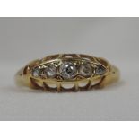 A lady's dress ring having five graduated diamonds in a gallery mount on an 18ct gold loop, size L