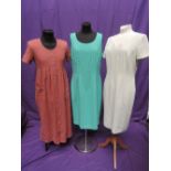 Three vintage lady's day dresses including pink button through dress by Orvis, spearmint green dress