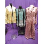 An Oriental style pink dressing gown having quilted collar and cuffs, a similar reversible short