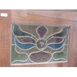 A late Victorian oak wardrobe in the Art Nouveau style having coloured glass panels and copper