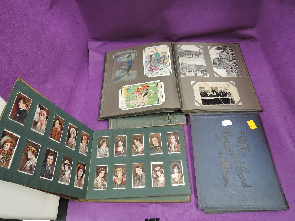 A collection in four albums of postcards and cigarette cards including real photo cards and Sinn