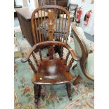 A 19th century beech and elm Windsor rocking armchair having slat and spindle back with solid seat