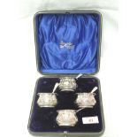 A cased set of four Edwardian silver salts of moulded oval form having rub over rims and four