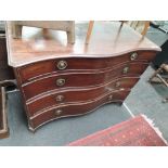 An early 19th century mahogany Serpentine front chest of 4 long cockbeaded graduated drawers on