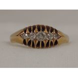 A lady's dress ring having five graduated diamonds in an indented claw mount on an 18ct gold loop,