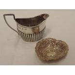 A Victorian silver cream jug having gadrooned decoration, reeded rim and architectural handle,