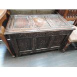 An 18th century oak kist/coffer having panel top with lunette and lozenge carved panel decoration on