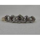 A lady's 5 stone diamond half eternity ring, total approx .25ct in claw set basket mounts on a