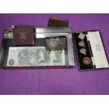 A small collection of coins, two banknotes, four football medals