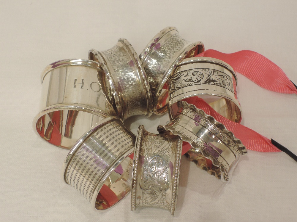 Seven HM silver napkin rings of various designs