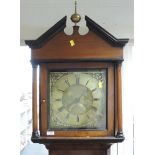 A late 18th century oak longcase clock having finial and shaped pillar hood containing square