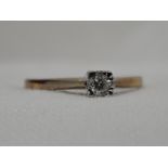 A lady's dress ring having a diamond solitaire, approx .05ct in an illusionary square setting to