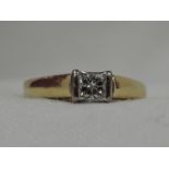 A lady's dress ring having a princess cut solitaire, approx 0.35ct in a tension mount to an 18ct