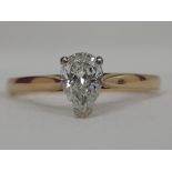 A lady's dress ring having a diamond pear shaped diamond approx .45ct in a three claw setting on