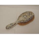 An Edwardian silver dressing table brush having cherubic decoration, Chester 1901, William Neale