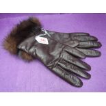 A pair of lady's brown leather gloves having fur trim, size 8