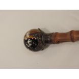 A Victorian gents walking cane having a spherical tigers eye knop within a silver coronet collar,