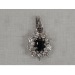 A sapphire and diamond cluster pendant, approx 0.6ct diamonds in a 14ct white gold mount on a