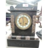 A late Victorian black slate and rouge marble mantel clock of architectural form, with striking