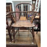 An early 19th century beech and elm Windsor armchair having spindle back, solid seat and H