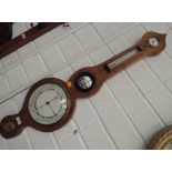 An early 19th century mahogany frame wheel barometer having humidity and thermometer scale