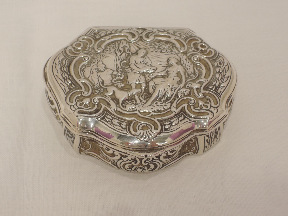 A continental silver lidded trinket box of shaped form having huntsman scene to lid, possibly