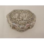 A continental silver lidded trinket box of shaped form having huntsman scene to lid, possibly