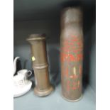 A large vintage military shell and similar cast fitment