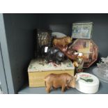 A selection of vintage advertising tins and wooden figures