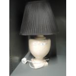 A vintage table top lamp with ceramic base