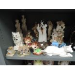 A selection of vintage figures and figurines including cats