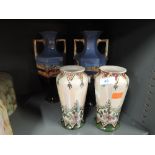 Two pairs of vases, one pair in an urn style with North African decor and a floral decorated pair