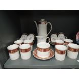 A mid century Elizabethan coffee service in burgandy and gilt on a white ground