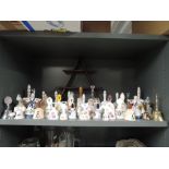 A large collection of ceramic bells and display shelf