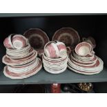 A selection of vintage ceramic dinner wares by Masons and Adams in a red and white palette