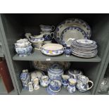 Two shelves or blue and white wares including Delft and blue flo