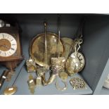 A selection of vintage brass wares including chestnut roasters