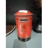 A vintage tin post office box style penny bank