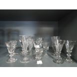 A selection of vintage and antique shot spirit and wine glasses of various designs