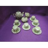 A mid 20th century miniature tea set having naturalist decoration