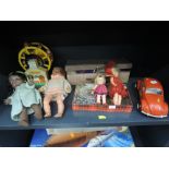 A shelf of mixed toys including Tonka Beetle car, Pedigree and similar dolls and accessories etc