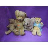 Three mid 20th century teddy bears having plastic eyes, stitched noses and mouths and jointed bodies